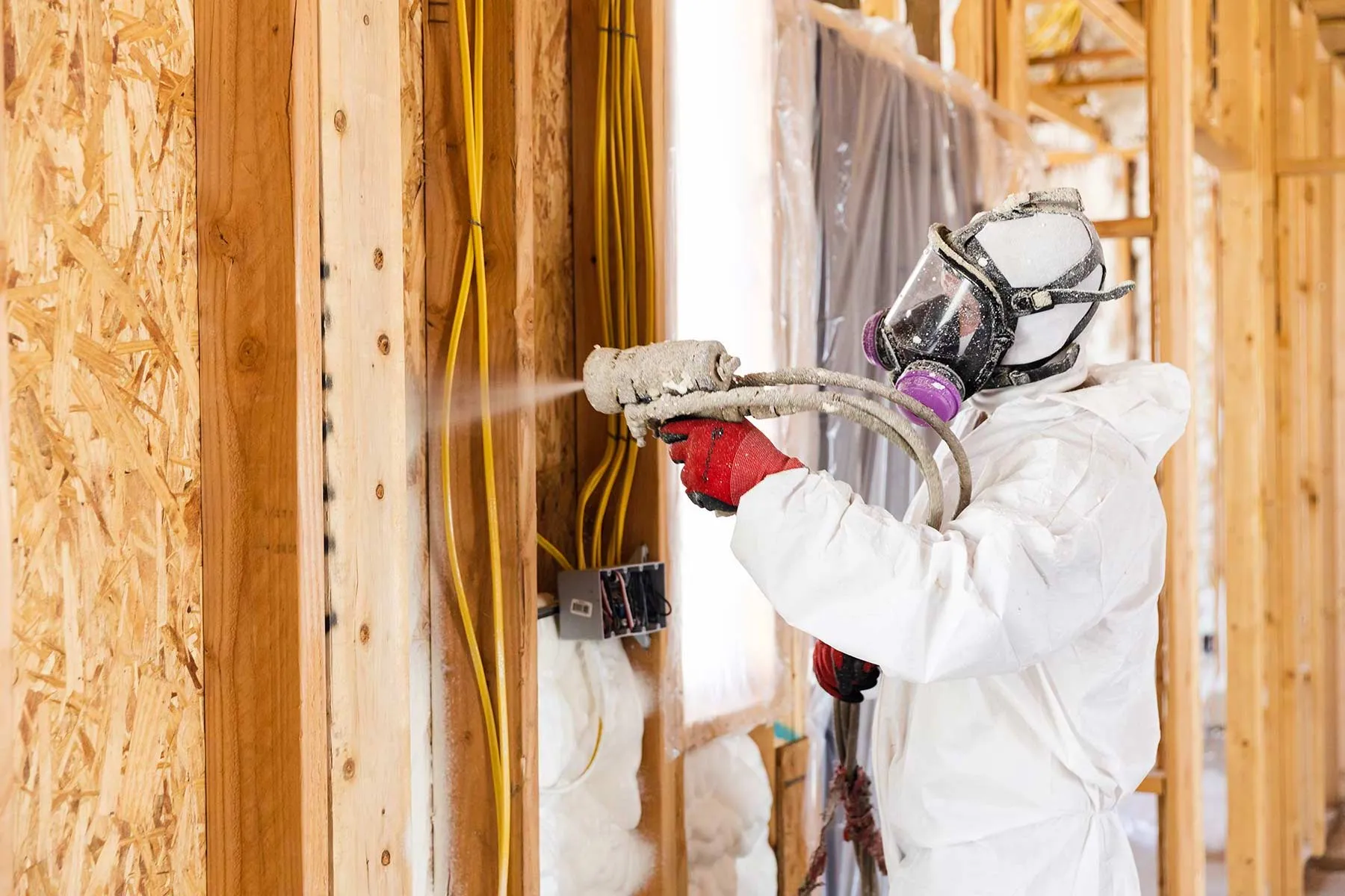 Installer applying foam inside framing